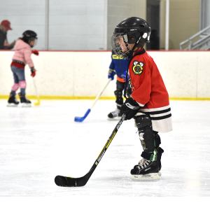 kid in hockey gear on the ice